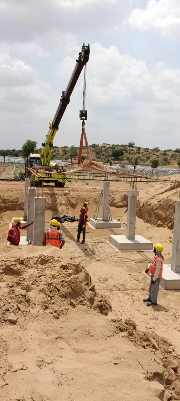 Column erection over cast pad foundations using mobile crane — Fortico Infra solar project site