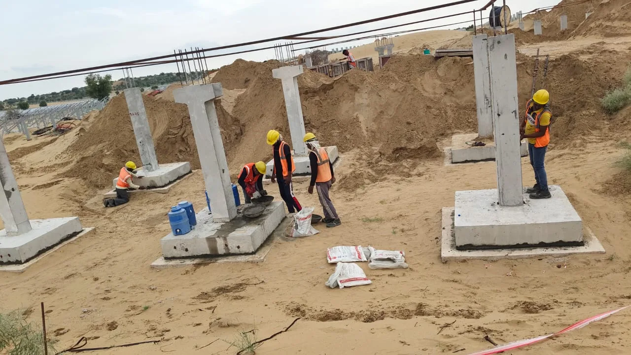 Crane positioning precast column at grid line — Fortico Infra solar project site