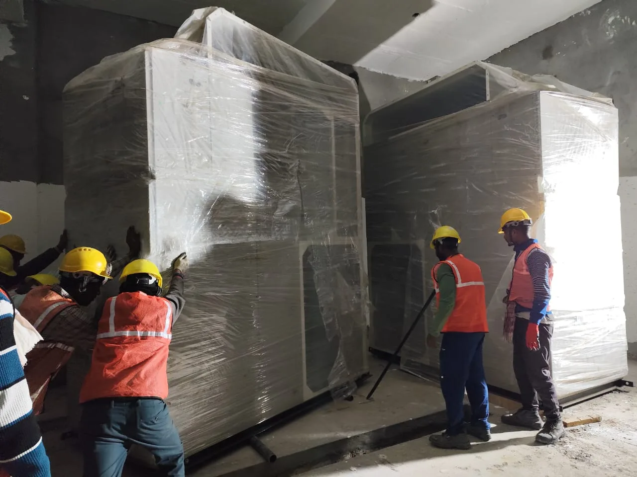 Site team guiding a precast wall panel into position — Fortico Infra solar project site