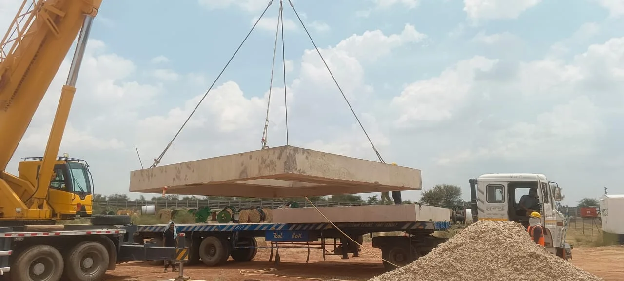 Crawler crane lifting a precast beam into place — Fortico Infra solar project site